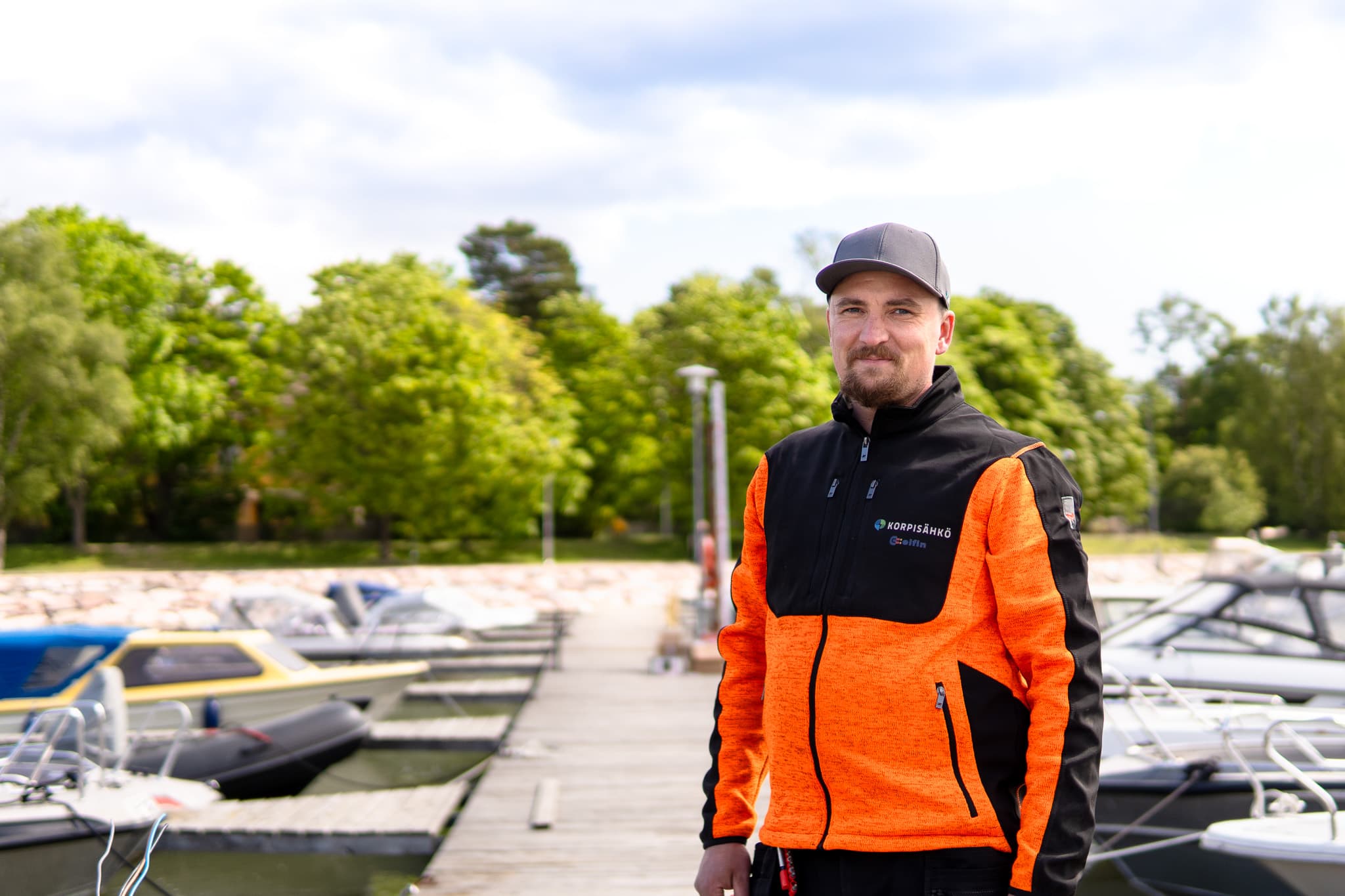Korpisähkön punainen pakettiauto ja asentaja työmaalla